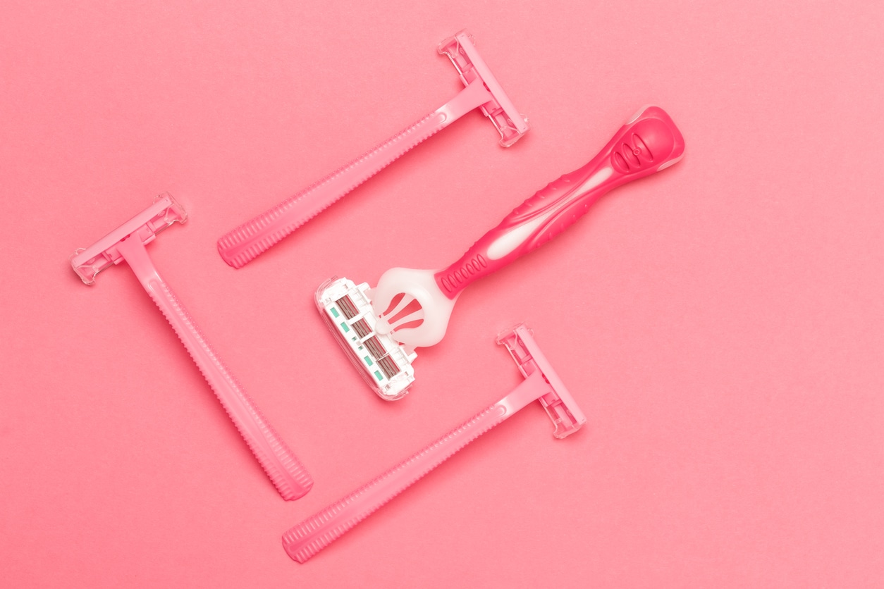 Female Hygiene Concepts. Closeup Image of Various Female Pink Disposable Razors Shavers Placed Bulk Over Trendy Pink Coral Background. Horizontal Shot